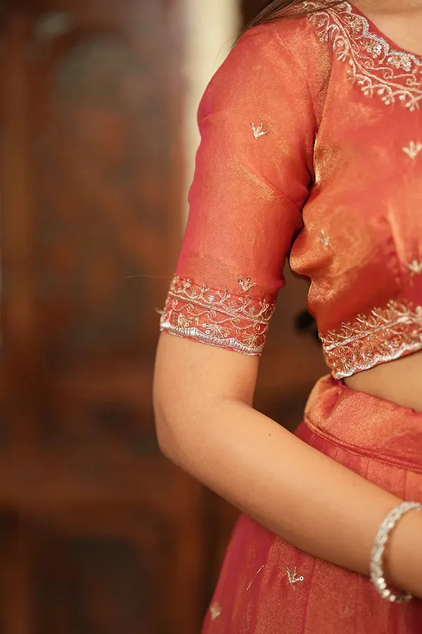Peach_Coral_Embroidered_Half_Saree_Lehenga_Set_with_Designer_Blouse,_Golden_Booti_Work_&_Elegant_Border_Detail