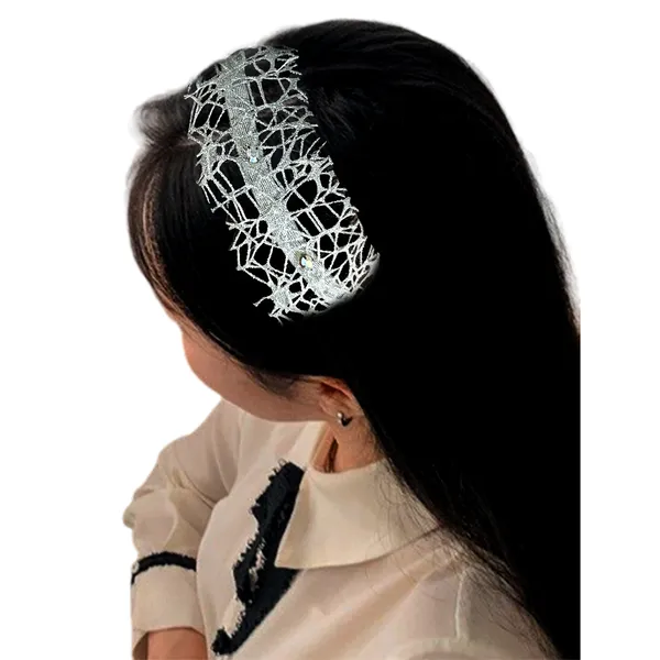 Elegant_ribbon-wrapped_hairband_featuring_shimmering_net_fabric_and_a_crystal_nag_adornment,_adding_sparkle_and_sophistication_to_your_hairstyle.