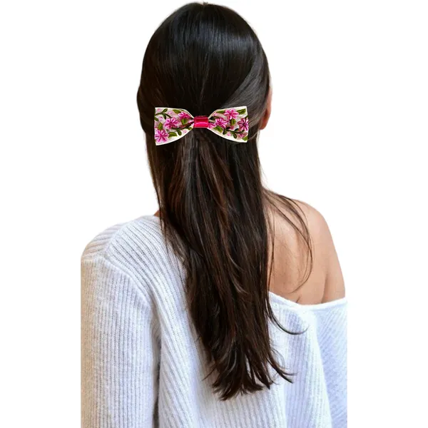 A_floral-printed_hair_bow_with_secure_clip_on_the_back_for_easy_attachment_and_stylish,_lasting_wear.