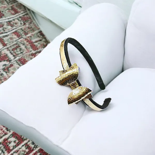 Playful_Sophistication:_Golden_Rexine_Bow_Hair_Band.
