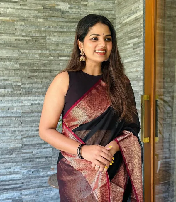 Elegant_Black_and_Maroon_Saree_with_Intricate_Gold_Patterns_and_Designer_Blouse