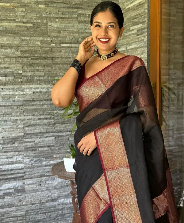 Elegant_Black_and_Maroon_Saree_with_Intricate_Gold_Patterns_and_Designer_Blouse