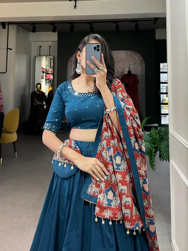 Dance_through_Navratri_nights_in_this_beautifully_printed_pure_cotton_lehenga_choli._Complete_with_a_matching_purse_and_intricate_coin_lace_detailing,_it's_perfect_for_the_celebrations