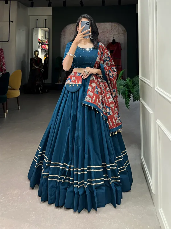 Dance_through_Navratri_nights_in_this_beautifully_printed_pure_cotton_lehenga_choli._Complete_with_a_matching_purse_and_intricate_coin_lace_detailing,_it's_perfect_for_the_celebrations