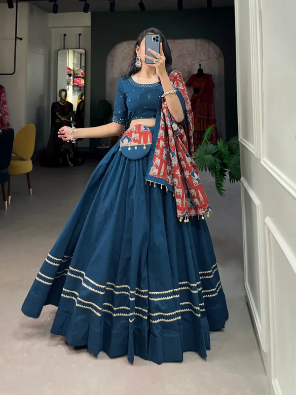 Dance_through_Navratri_nights_in_this_beautifully_printed_pure_cotton_lehenga_choli._Complete_with_a_matching_purse_and_intricate_coin_lace_detailing,_it's_perfect_for_the_celebrations