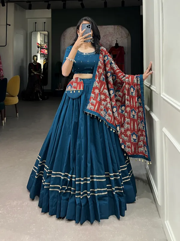 Dance_through_Navratri_nights_in_this_beautifully_printed_pure_cotton_lehenga_choli._Complete_with_a_matching_purse_and_intricate_coin_lace_detailing,_it's_perfect_for_the_celebrations