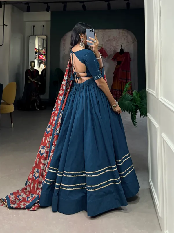 Dance_through_Navratri_nights_in_this_beautifully_printed_pure_cotton_lehenga_choli._Complete_with_a_matching_purse_and_intricate_coin_lace_detailing,_it's_perfect_for_the_celebrations