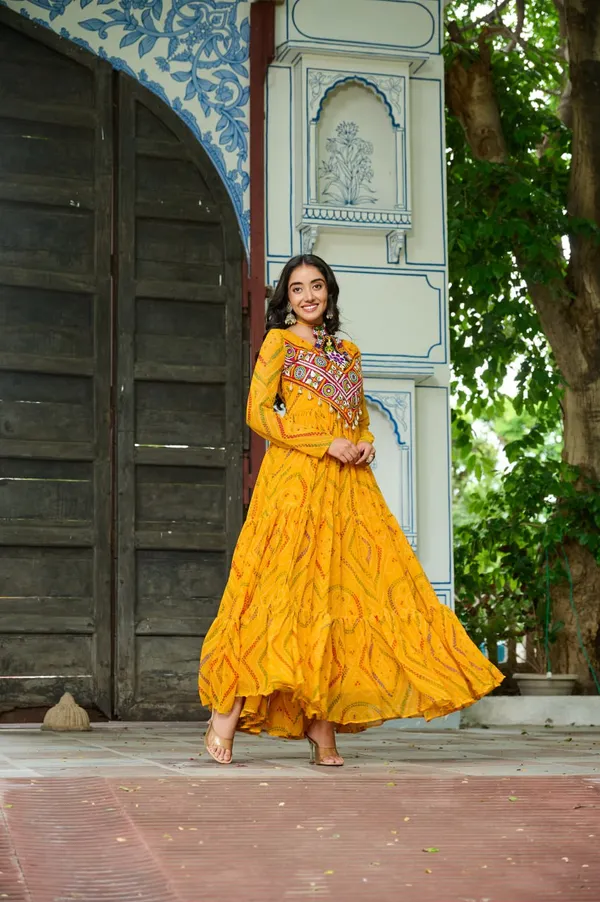 Celebrate_this_Navratri_in_full_color_and_culture_with_our_stunning_traditional_maxi_dresses._Featuring_bold_Bandhani_prints_and_handcrafted_mirror-work_yokes,_each_outfit_radiates_ethnic_charm._Choose_your_festive_hue_—_Sunshine_Yellow,_Royal_Purple,_Electric_Blue,_or_Fiery_Red_—_and_dance_through_the_nights_in_comfort_and_elegance.
