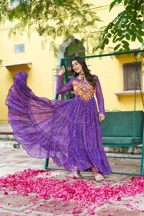 Celebrate_this_Navratri_in_full_color_and_culture_with_our_stunning_traditional_maxi_dresses._Featuring_bold_Bandhani_prints_and_handcrafted_mirror-work_yokes,_each_outfit_radiates_ethnic_charm._Choose_your_festive_hue_—_Sunshine_Yellow,_Royal_Purple,_Electric_Blue,_or_Fiery_Red_—_and_dance_through_the_nights_in_comfort_and_elegance.