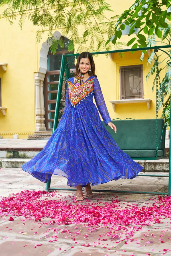 Celebrate_this_Navratri_in_full_color_and_culture_with_our_stunning_traditional_maxi_dresses._Featuring_bold_Bandhani_prints_and_handcrafted_mirror-work_yokes,_each_outfit_radiates_ethnic_charm._Choose_your_festive_hue_—_Sunshine_Yellow,_Royal_Purple,_Electric_Blue,_or_Fiery_Red_—_and_dance_through_the_nights_in_comfort_and_elegance.