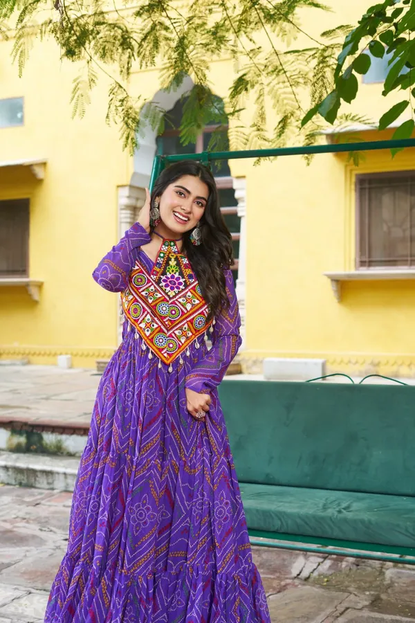Celebrate_this_Navratri_in_full_color_and_culture_with_our_stunning_traditional_maxi_dresses._Featuring_bold_Bandhani_prints_and_handcrafted_mirror-work_yokes,_each_outfit_radiates_ethnic_charm._Choose_your_festive_hue_—_Sunshine_Yellow,_Royal_Purple,_Electric_Blue,_or_Fiery_Red_—_and_dance_through_the_nights_in_comfort_and_elegance.
