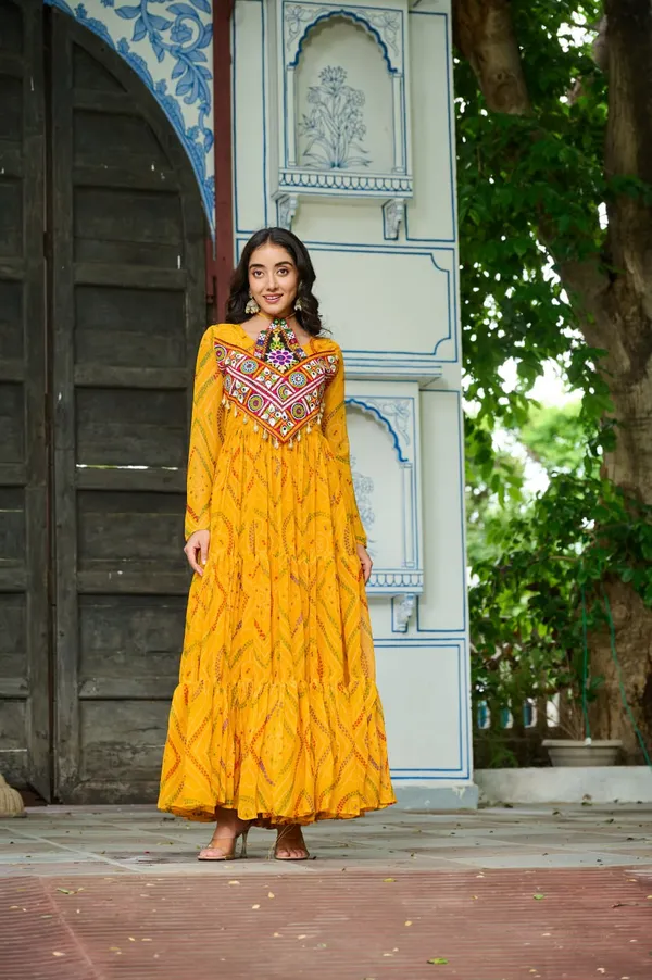 Celebrate_this_Navratri_in_full_color_and_culture_with_our_stunning_traditional_maxi_dresses._Featuring_bold_Bandhani_prints_and_handcrafted_mirror-work_yokes,_each_outfit_radiates_ethnic_charm._Choose_your_festive_hue_—_Sunshine_Yellow,_Royal_Purple,_Electric_Blue,_or_Fiery_Red_—_and_dance_through_the_nights_in_comfort_and_elegance.