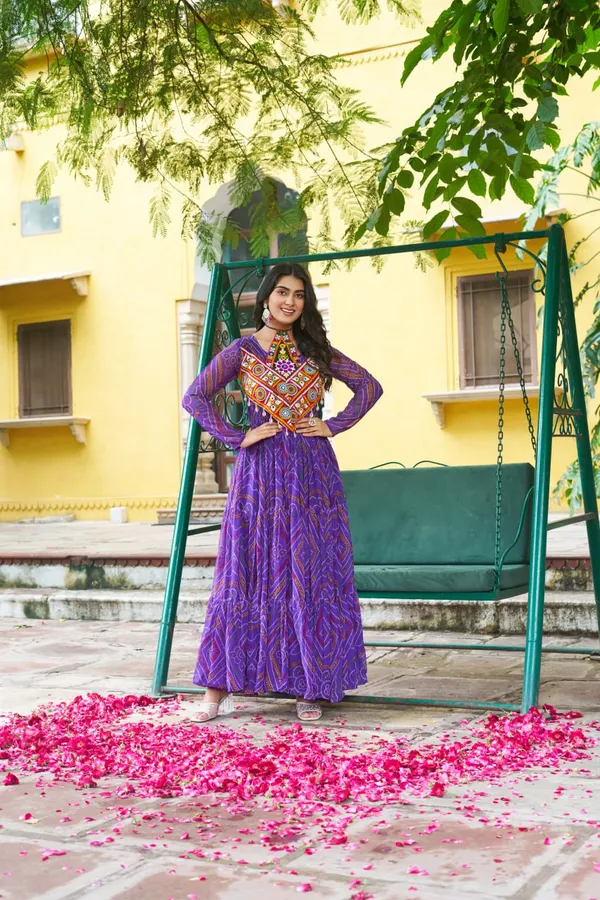 Celebrate_this_Navratri_in_full_color_and_culture_with_our_stunning_traditional_maxi_dresses._Featuring_bold_Bandhani_prints_and_handcrafted_mirror-work_yokes,_each_outfit_radiates_ethnic_charm._Choose_your_festive_hue_—_Sunshine_Yellow,_Royal_Purple,_Electric_Blue,_or_Fiery_Red_—_and_dance_through_the_nights_in_comfort_and_elegance.