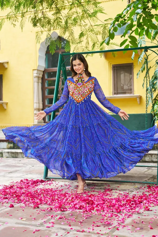 Celebrate_this_Navratri_in_full_color_and_culture_with_our_stunning_traditional_maxi_dresses._Featuring_bold_Bandhani_prints_and_handcrafted_mirror-work_yokes,_each_outfit_radiates_ethnic_charm._Choose_your_festive_hue_—_Sunshine_Yellow,_Royal_Purple,_Electric_Blue,_or_Fiery_Red_—_and_dance_through_the_nights_in_comfort_and_elegance.
