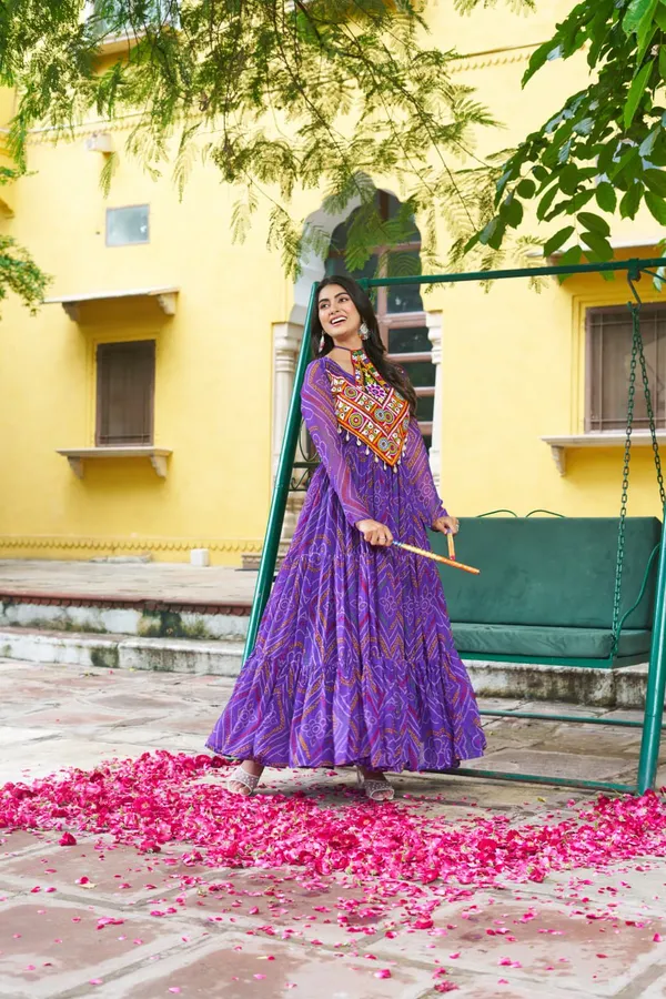 Celebrate_this_Navratri_in_full_color_and_culture_with_our_stunning_traditional_maxi_dresses._Featuring_bold_Bandhani_prints_and_handcrafted_mirror-work_yokes,_each_outfit_radiates_ethnic_charm._Choose_your_festive_hue_—_Sunshine_Yellow,_Royal_Purple,_Electric_Blue,_or_Fiery_Red_—_and_dance_through_the_nights_in_comfort_and_elegance.