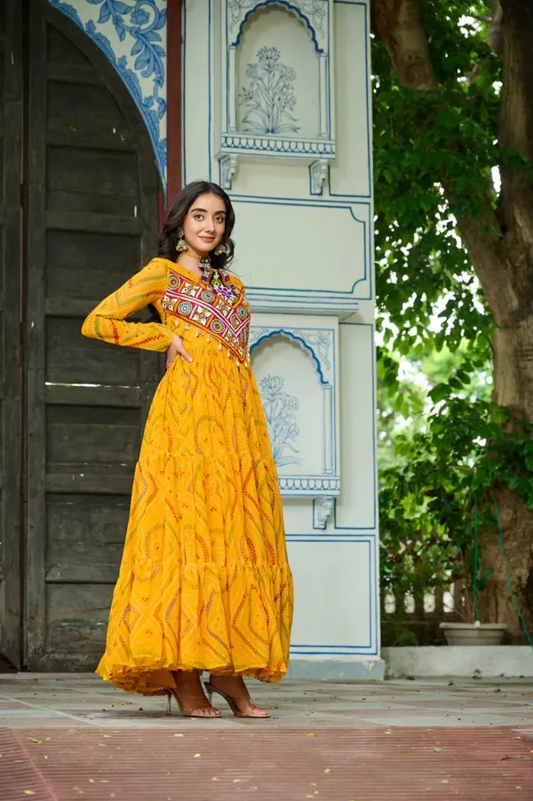Celebrate_this_Navratri_in_full_color_and_culture_with_our_stunning_traditional_maxi_dresses._Featuring_bold_Bandhani_prints_and_handcrafted_mirror-work_yokes,_each_outfit_radiates_ethnic_charm._Choose_your_festive_hue_—_Sunshine_Yellow,_Royal_Purple,_Electric_Blue,_or_Fiery_Red_—_and_dance_through_the_nights_in_comfort_and_elegance.