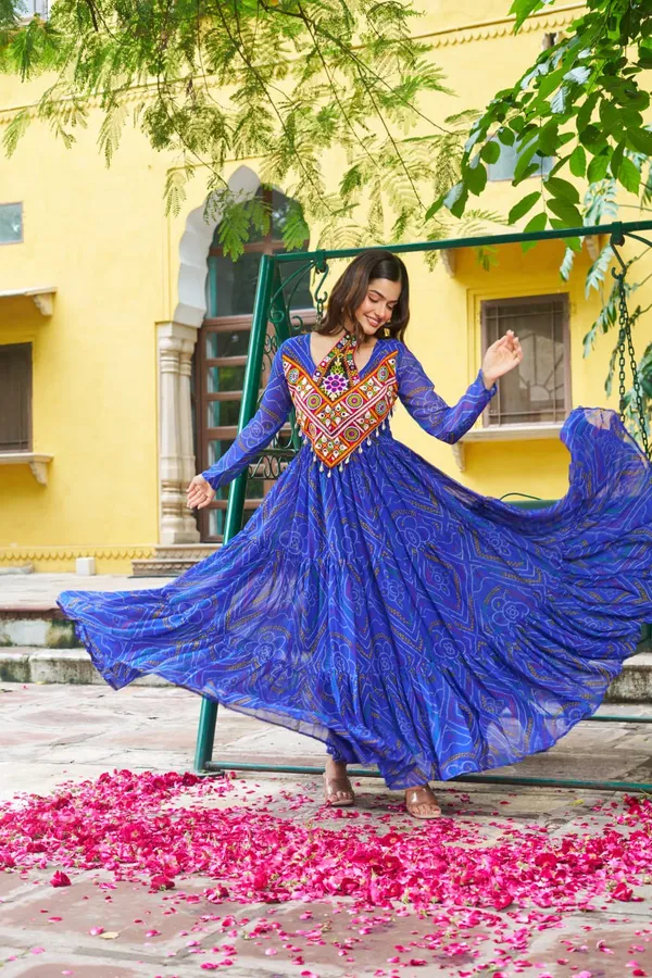 Celebrate_this_Navratri_in_full_color_and_culture_with_our_stunning_traditional_maxi_dresses._Featuring_bold_Bandhani_prints_and_handcrafted_mirror-work_yokes,_each_outfit_radiates_ethnic_charm._Choose_your_festive_hue_—_Sunshine_Yellow,_Royal_Purple,_Electric_Blue,_or_Fiery_Red_—_and_dance_through_the_nights_in_comfort_and_elegance.