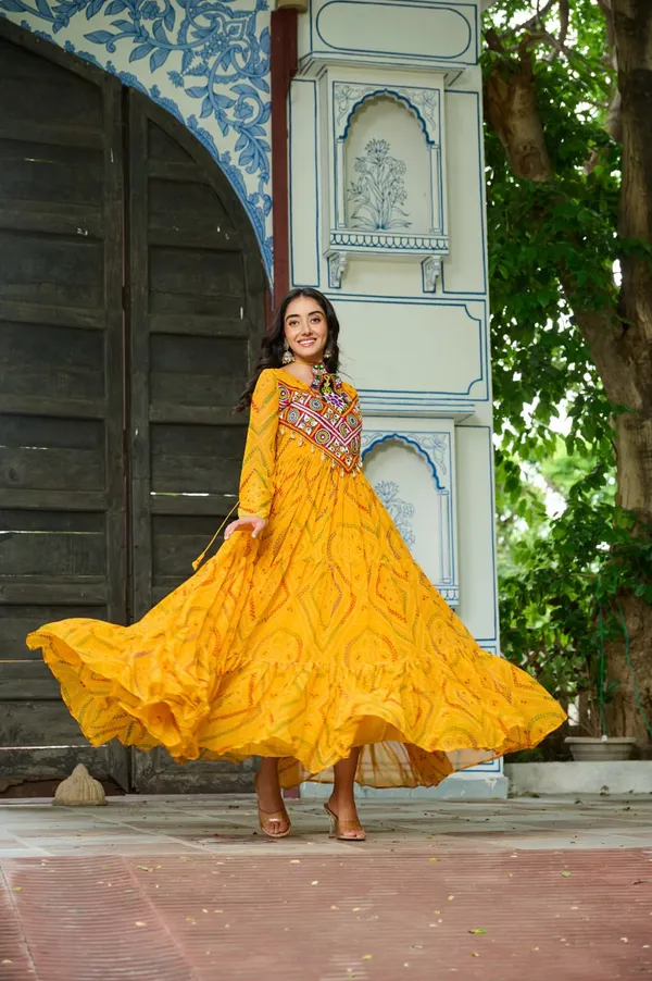 Celebrate_this_Navratri_in_full_color_and_culture_with_our_stunning_traditional_maxi_dresses._Featuring_bold_Bandhani_prints_and_handcrafted_mirror-work_yokes,_each_outfit_radiates_ethnic_charm._Choose_your_festive_hue_—_Sunshine_Yellow,_Royal_Purple,_Electric_Blue,_or_Fiery_Red_—_and_dance_through_the_nights_in_comfort_and_elegance.