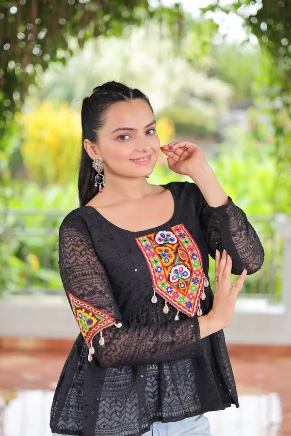Featuring_mirror-work_embroidered_yokes,_tie-dye_Bandhani_patterns,_and_radiant_colors_like_emerald_green,_mustard_yellow,_and_fuchsia_pink_–_these_flowy_ensembles_are_a_celebration_in_themselves