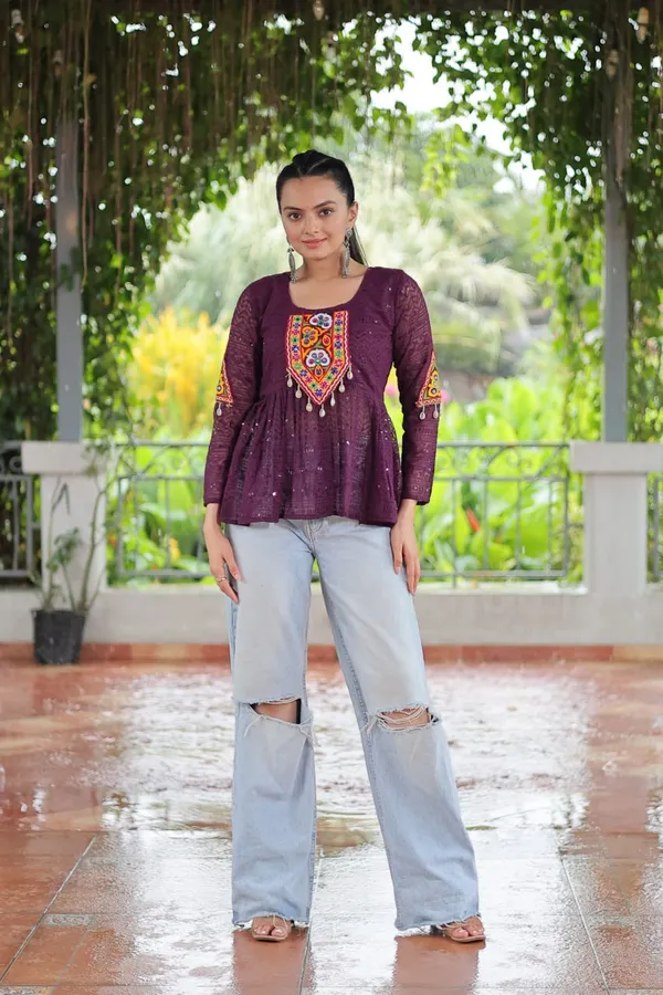 Featuring_mirror-work_embroidered_yokes,_tie-dye_Bandhani_patterns,_and_radiant_colors_like_emerald_green,_mustard_yellow,_and_fuchsia_pink_–_these_flowy_ensembles_are_a_celebration_in_themselves