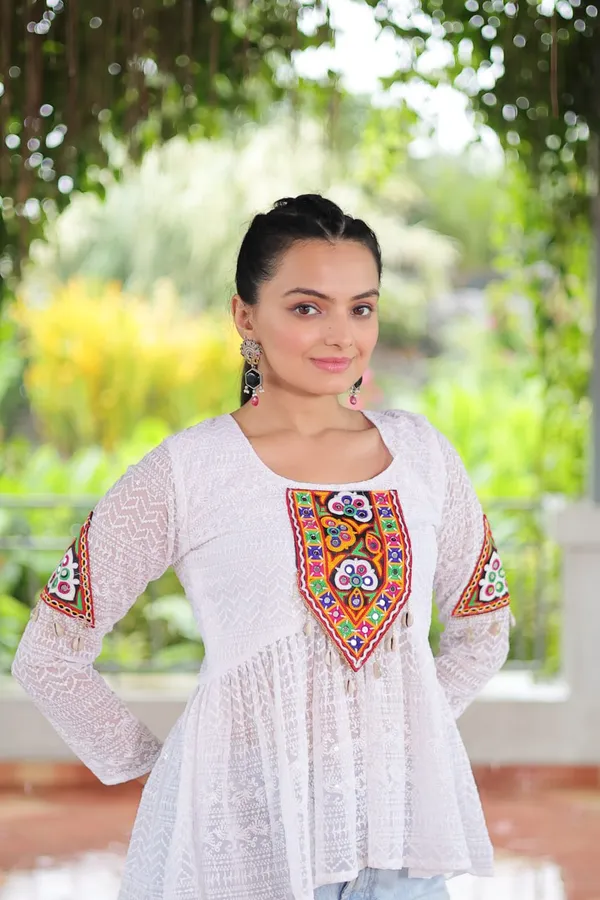Featuring_mirror-work_embroidered_yokes,_tie-dye_Bandhani_patterns,_and_radiant_colors_like_emerald_green,_mustard_yellow,_and_fuchsia_pink_–_these_flowy_ensembles_are_a_celebration_in_themselves