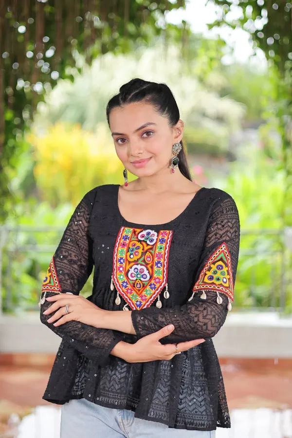 Featuring_mirror-work_embroidered_yokes,_tie-dye_Bandhani_patterns,_and_radiant_colors_like_emerald_green,_mustard_yellow,_and_fuchsia_pink_–_these_flowy_ensembles_are_a_celebration_in_themselves