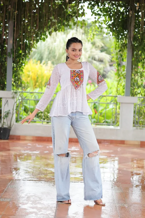 Featuring_mirror-work_embroidered_yokes,_tie-dye_Bandhani_patterns,_and_radiant_colors_like_emerald_green,_mustard_yellow,_and_fuchsia_pink_–_these_flowy_ensembles_are_a_celebration_in_themselves