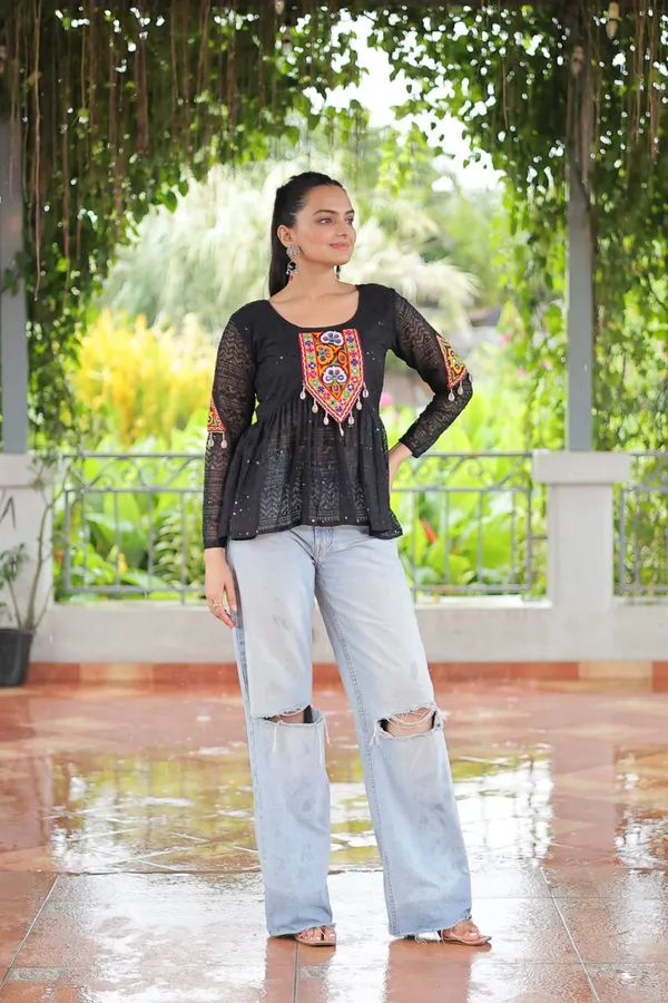 Featuring_mirror-work_embroidered_yokes,_tie-dye_Bandhani_patterns,_and_radiant_colors_like_emerald_green,_mustard_yellow,_and_fuchsia_pink_–_these_flowy_ensembles_are_a_celebration_in_themselves