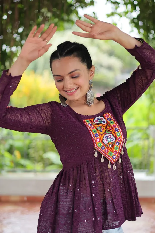 Featuring_mirror-work_embroidered_yokes,_tie-dye_Bandhani_patterns,_and_radiant_colors_like_emerald_green,_mustard_yellow,_and_fuchsia_pink_–_these_flowy_ensembles_are_a_celebration_in_themselves