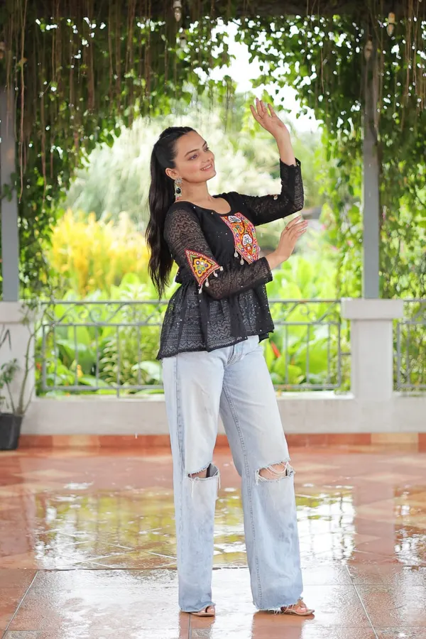 Featuring_mirror-work_embroidered_yokes,_tie-dye_Bandhani_patterns,_and_radiant_colors_like_emerald_green,_mustard_yellow,_and_fuchsia_pink_–_these_flowy_ensembles_are_a_celebration_in_themselves