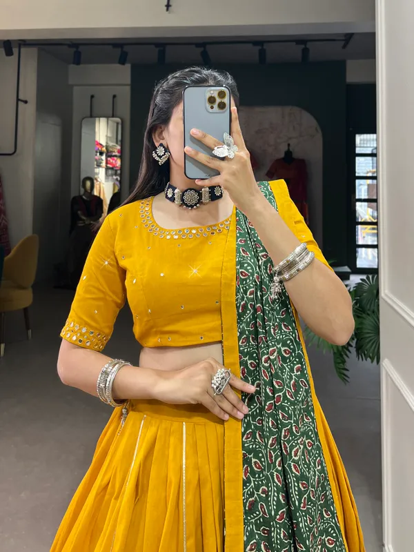 Dance_through_Navratri_nights_in_this_beautifully_printed_pure_cotton_lehenga_choli._Complete_with_a_matching_purse_and_intricate_coin_lace_detailing,_it's_perfect_for_the_celebrations