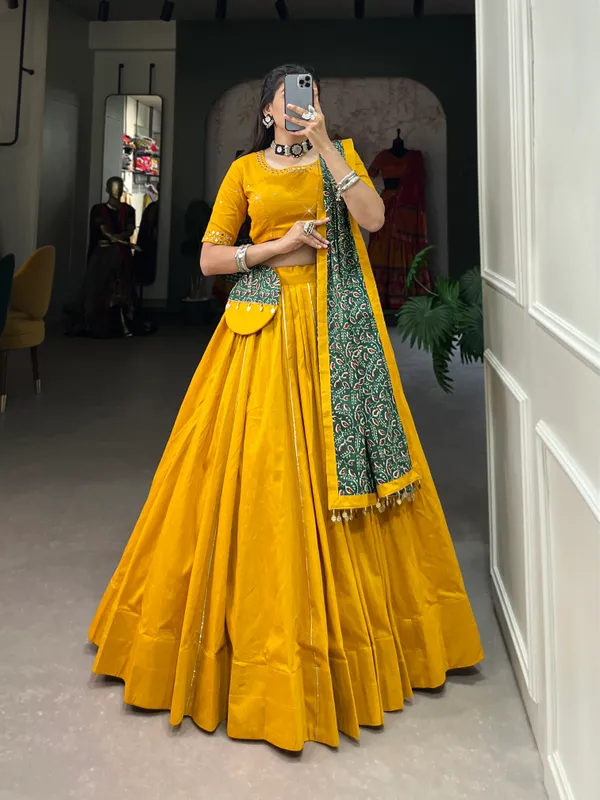 Dance_through_Navratri_nights_in_this_beautifully_printed_pure_cotton_lehenga_choli._Complete_with_a_matching_purse_and_intricate_coin_lace_detailing,_it's_perfect_for_the_celebrations