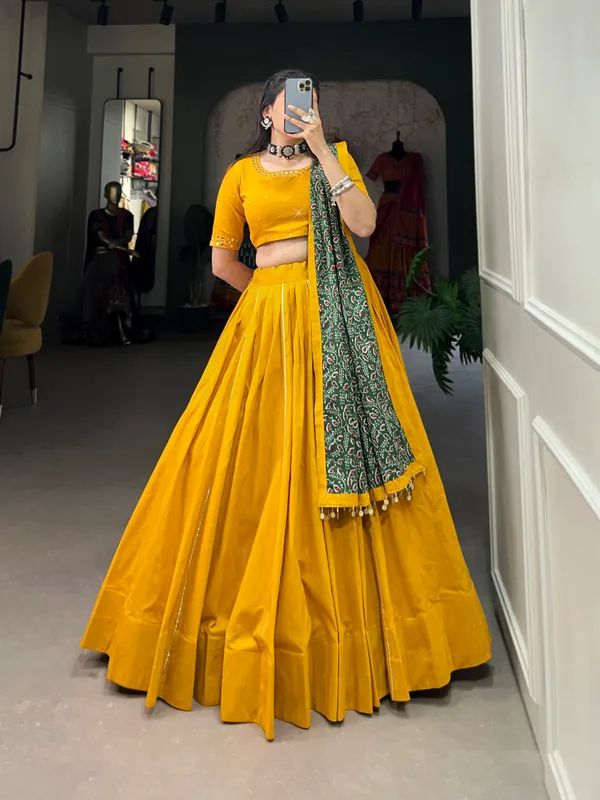 Dance_through_Navratri_nights_in_this_beautifully_printed_pure_cotton_lehenga_choli._Complete_with_a_matching_purse_and_intricate_coin_lace_detailing,_it's_perfect_for_the_celebrations