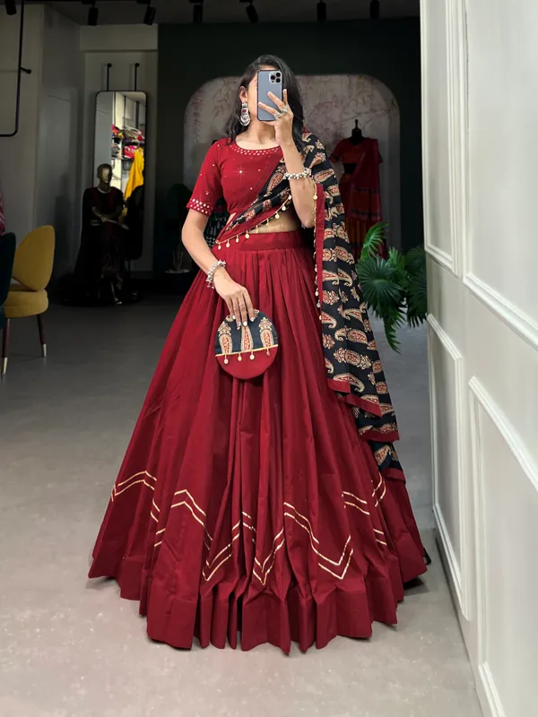 Dance_through_Navratri_nights_in_this_beautifully_printed_pure_cotton_lehenga_choli._Complete_with_a_matching_purse_and_intricate_coin_lace_detailing,_it's_perfect_for_the_celebrations