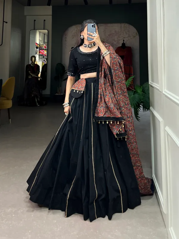 Dance_through_Navratri_nights_in_this_beautifully_printed_pure_cotton_lehenga_choli._Complete_with_a_matching_purse_and_intricate_coin_lace_detailing,_it's_perfect_for_the_celebrations