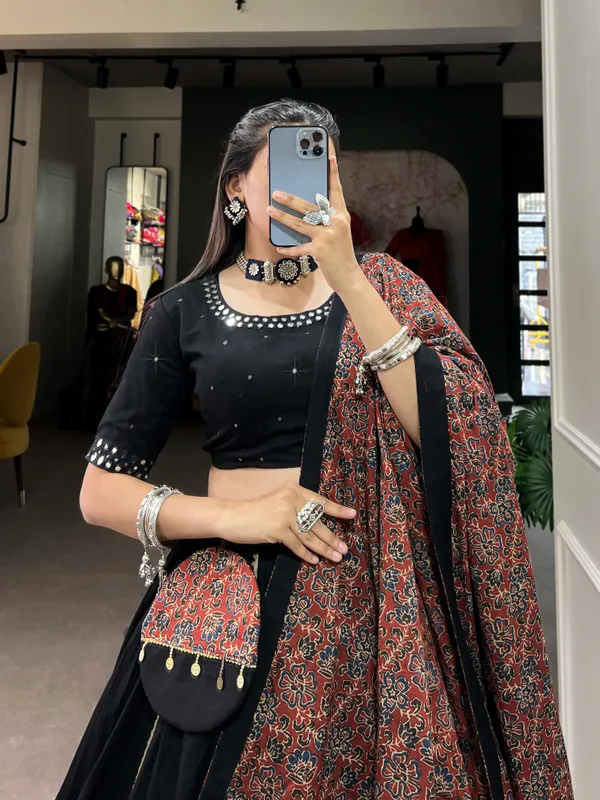 Dance_through_Navratri_nights_in_this_beautifully_printed_pure_cotton_lehenga_choli._Complete_with_a_matching_purse_and_intricate_coin_lace_detailing,_it's_perfect_for_the_celebrations