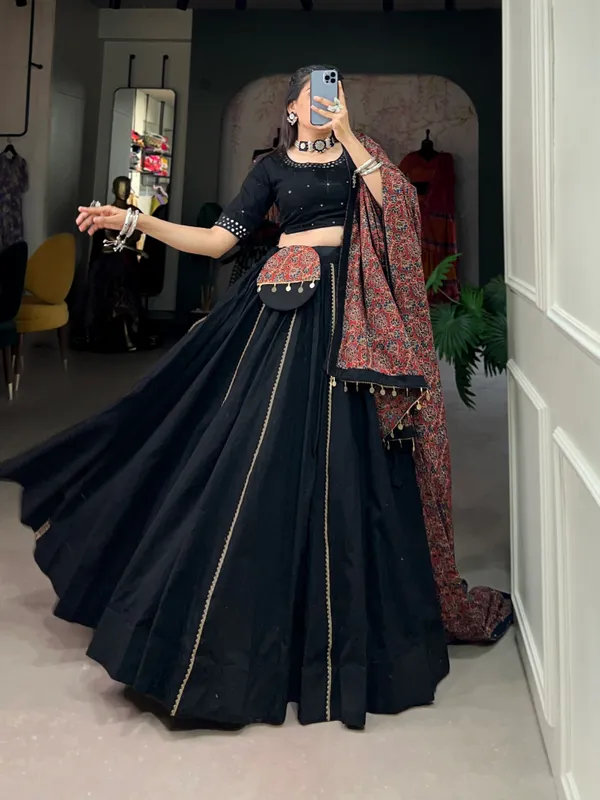 Dance_through_Navratri_nights_in_this_beautifully_printed_pure_cotton_lehenga_choli._Complete_with_a_matching_purse_and_intricate_coin_lace_detailing,_it's_perfect_for_the_celebrations