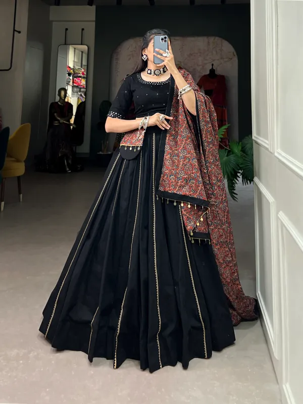 Dance_through_Navratri_nights_in_this_beautifully_printed_pure_cotton_lehenga_choli._Complete_with_a_matching_purse_and_intricate_coin_lace_detailing,_it's_perfect_for_the_celebrations