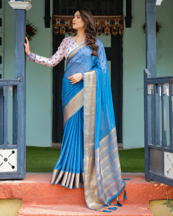 Vibrant_Sky_Blue_Plain_Chiffon_Saree_with_Gold_Zari_Border,_Floral_Printed_Blouse_&_Tassel_Accents