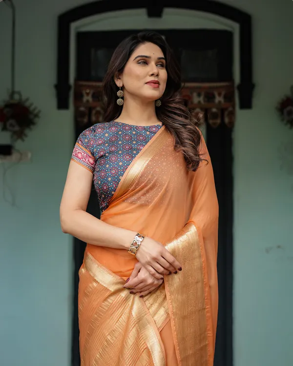 Elegant_Tangerine_Orange_Plain_Chiffon_Saree_with_Gold_Zari_Border,_Geometric_Printed_Blouse_&_Tassel_Detailing