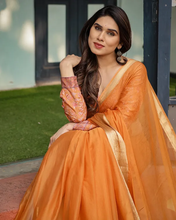 Sunset_Orange_Plain_Chiffon_Saree_with_Gold_Zari_Border,_Floral_Embroidered_Blouse_&_Tassel_Detailing
