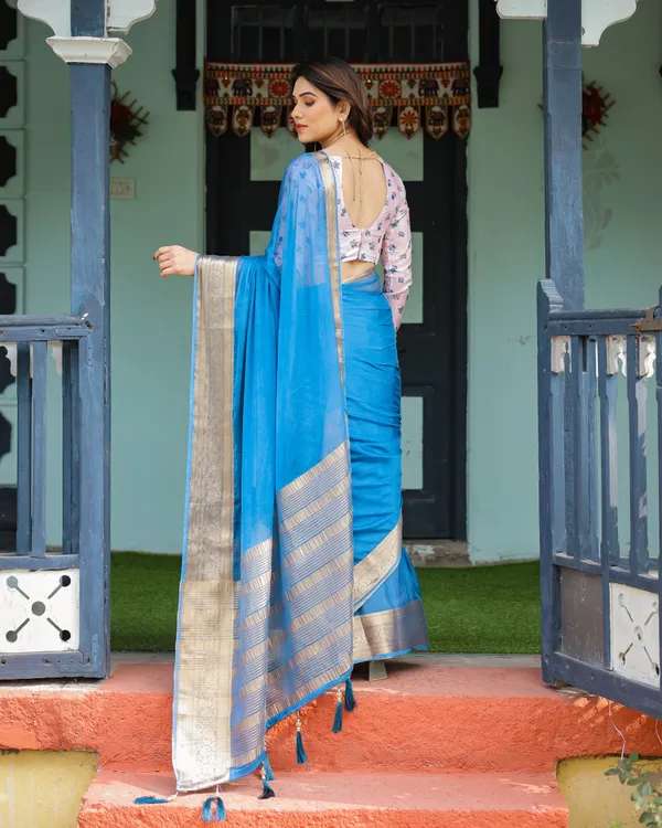 Vibrant_Sky_Blue_Plain_Chiffon_Saree_with_Gold_Zari_Border,_Floral_Printed_Blouse_&_Tassel_Accents