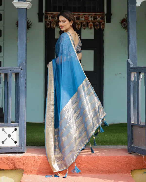 Vibrant_Peacock_Blue_Plain_Chiffon_Saree_with_Gold_Zari_Border,_Floral_Printed_Blouse_&_Tassel_Accents