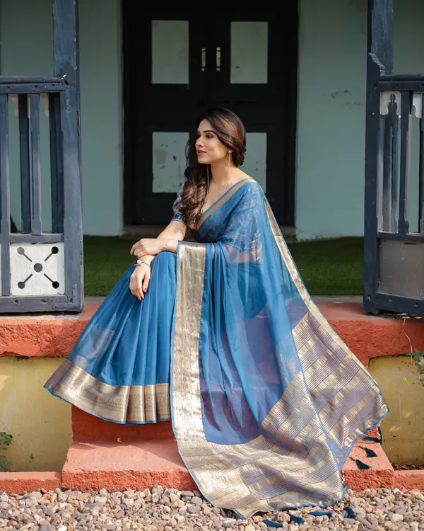 Vibrant_Peacock_Blue_Plain_Chiffon_Saree_with_Gold_Zari_Border,_Floral_Printed_Blouse_&_Tassel_Accents