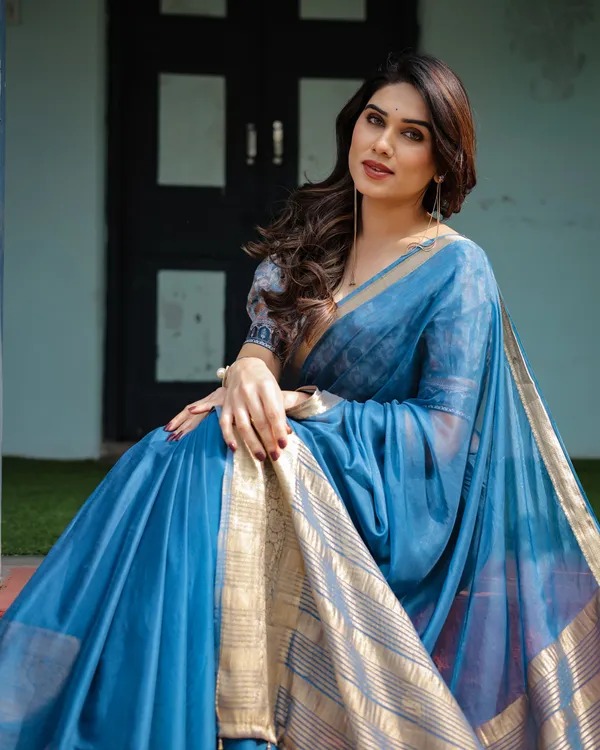 Vibrant_Peacock_Blue_Plain_Chiffon_Saree_with_Gold_Zari_Border,_Floral_Printed_Blouse_&_Tassel_Accents