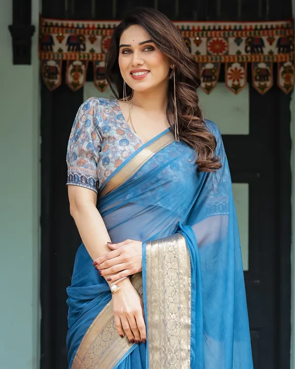 Vibrant_Peacock_Blue_Plain_Chiffon_Saree_with_Gold_Zari_Border,_Floral_Printed_Blouse_&_Tassel_Accents