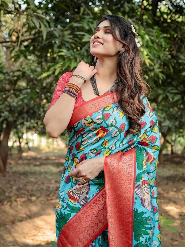 Aqua_Blue_Tussar_Silk_Saree_with_Vibrant_Nature-Inspired_Prints_and_Red_Zari_Border