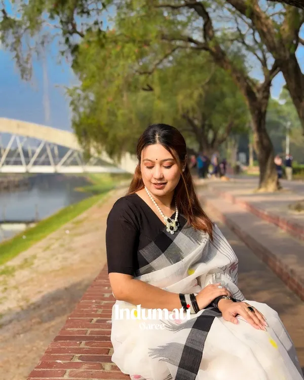 Shvet_Pushp_-_White_Linen_Saree_with_Black_Border_&_Yellow-Purple_Motifs_with_Blouse_Piece