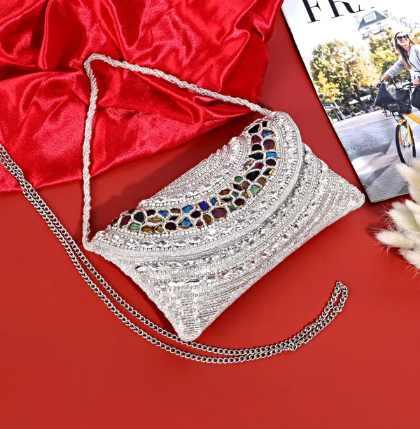 Osty_Celestia_–_Handcrafted_Silver_Zari_Clutch_with_Multicolor_Gem_Embellishment_&_Dual_Carry_Chain_for_Wedding_&_Occasion_Styling