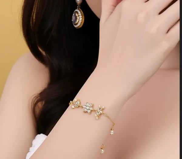 Elegant_Gold-Toned_Starburst_Bracelet_with_Crystal_Accents_and_Delicate_Pearl_Drops